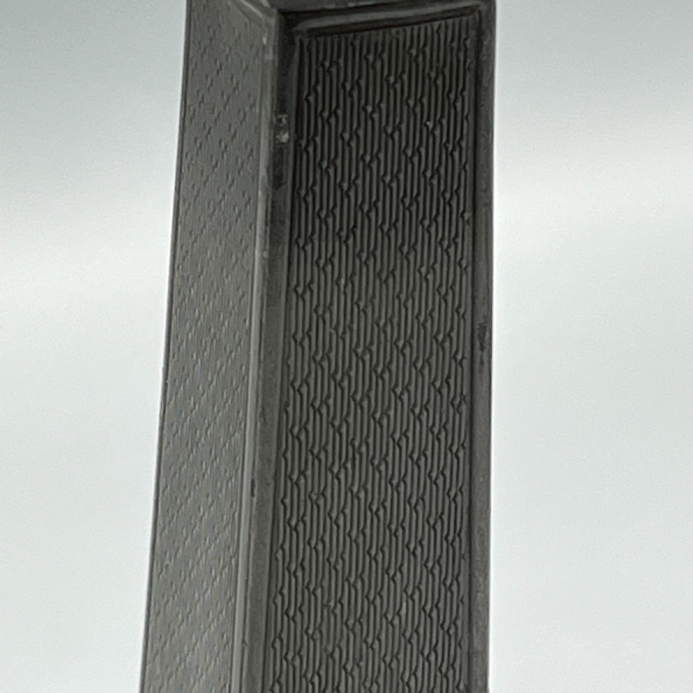 A pair of dark grey Art Deco pewter candlesticks featuring stepped square bases and tapered central columns. View X