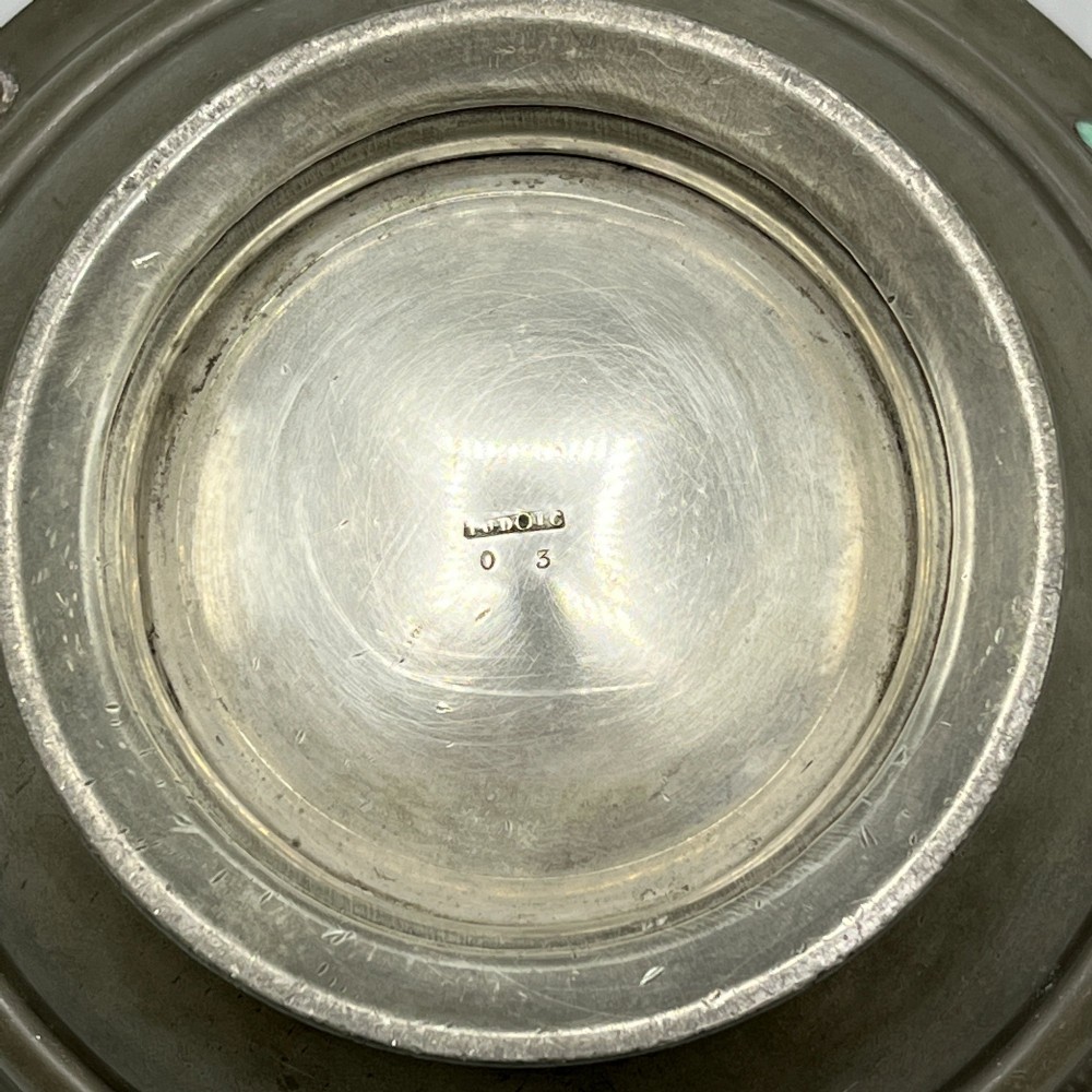 An Arts and Crafts pewter porringer bowl featuring twin raised handles, a pedestal base, and small turquoise cabochons set into the exterior rim. View XII