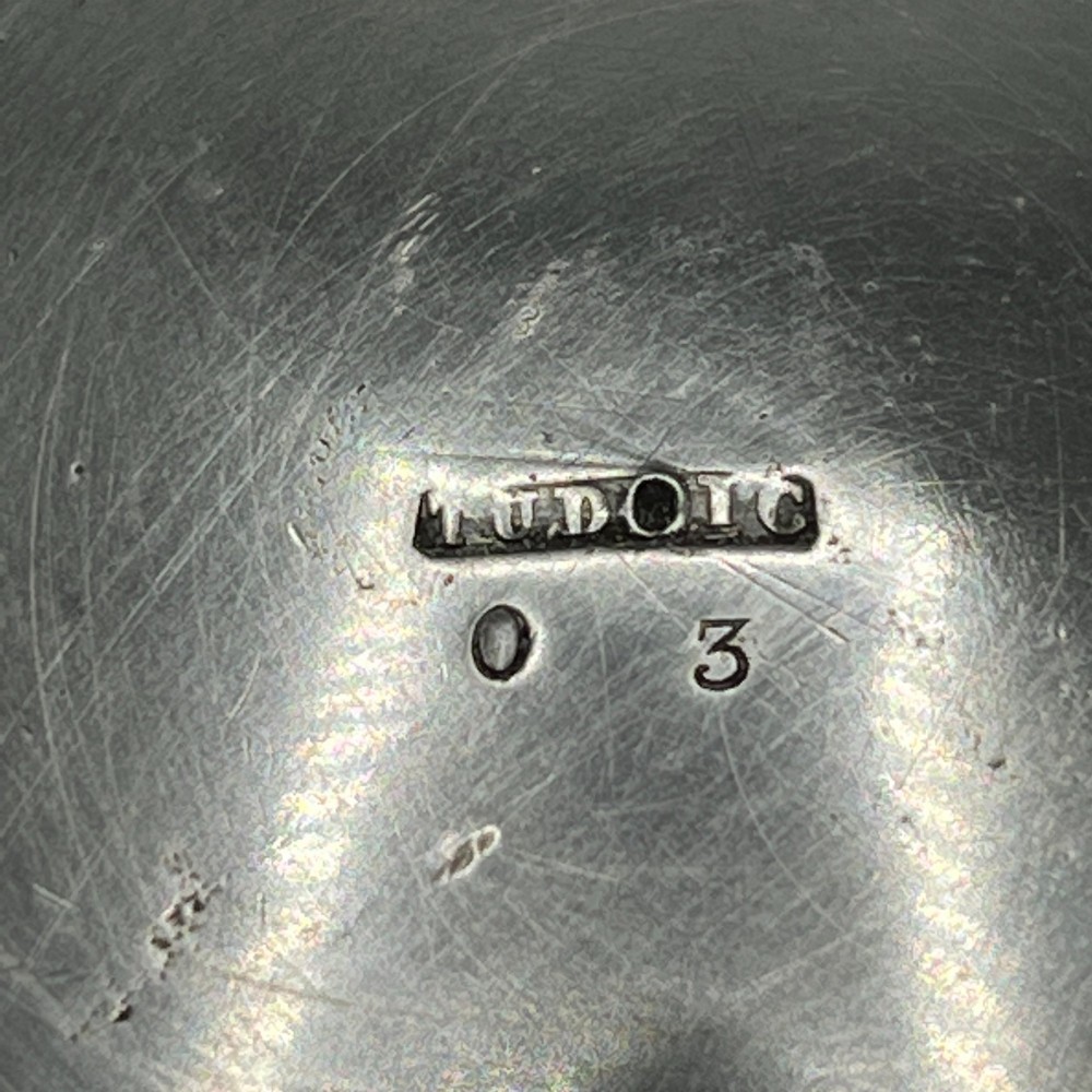 An Arts and Crafts pewter porringer bowl featuring twin raised handles, a pedestal base, and small turquoise cabochons set into the exterior rim. View XIII