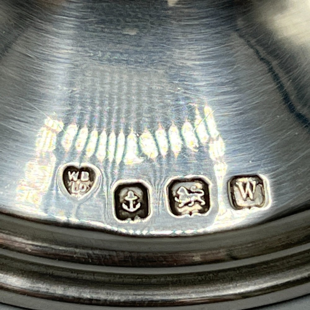 An Art Deco sterling silver capstan inkwell featuring a smooth hinged lid, circular stepped base, and visible hallmarks. View II
