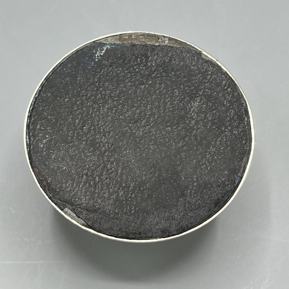 An Art Deco sterling silver capstan inkwell featuring a smooth hinged lid, circular stepped base, and visible hallmarks. View XIII