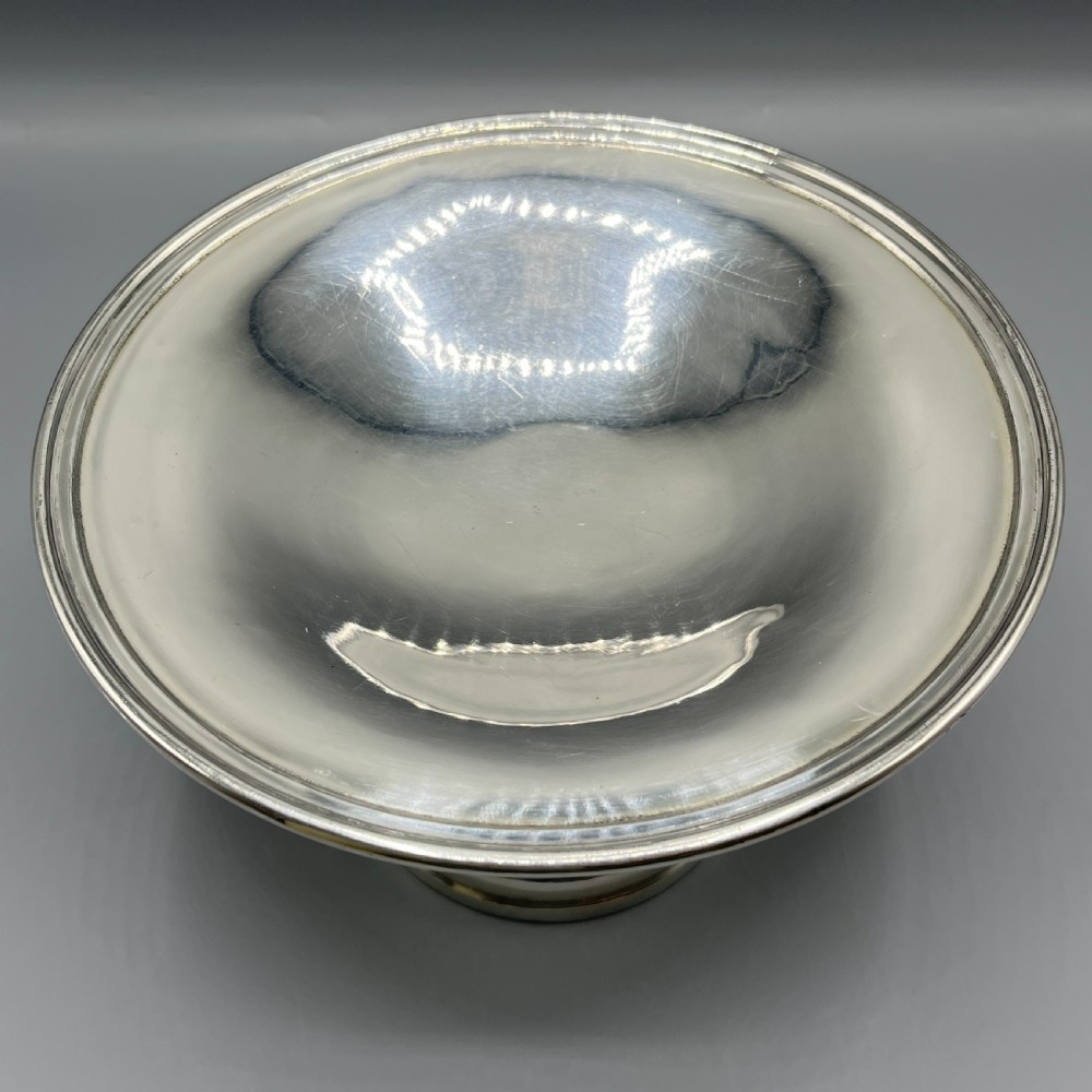 A circular silver-plated tazza dish with a shallow tray resting on a moulded pedestal stem and flared base. View IV
