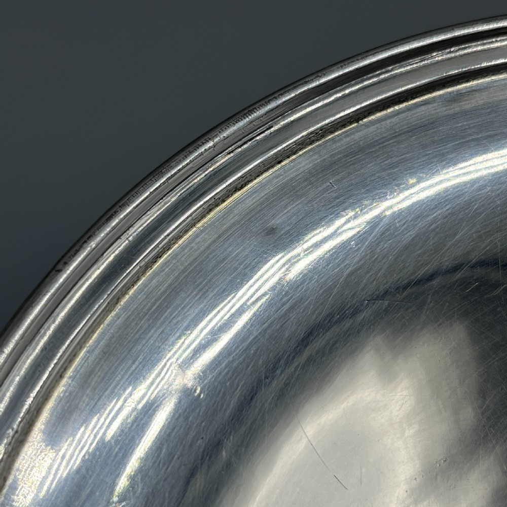 A circular silver-plated tazza dish with a shallow tray resting on a moulded pedestal stem and flared base. View VI