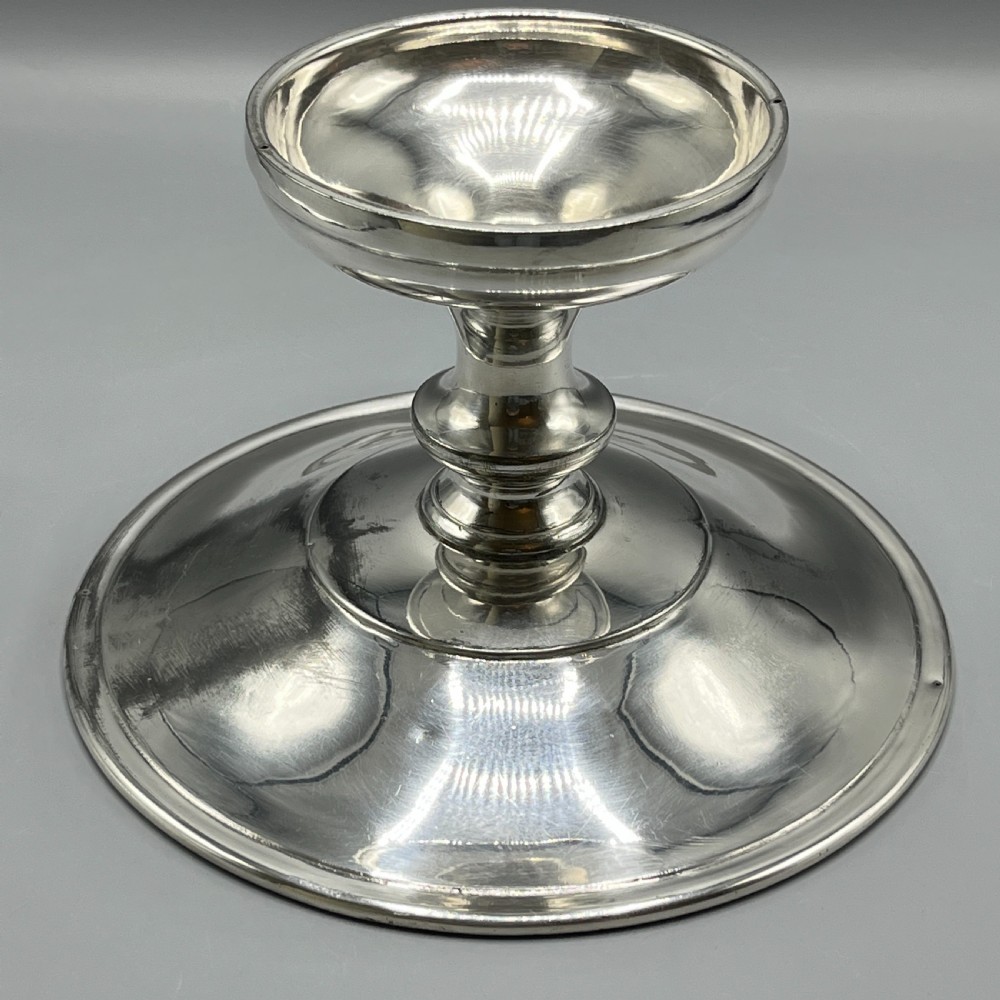 A circular silver-plated tazza dish with a shallow tray resting on a moulded pedestal stem and flared base. View XII
