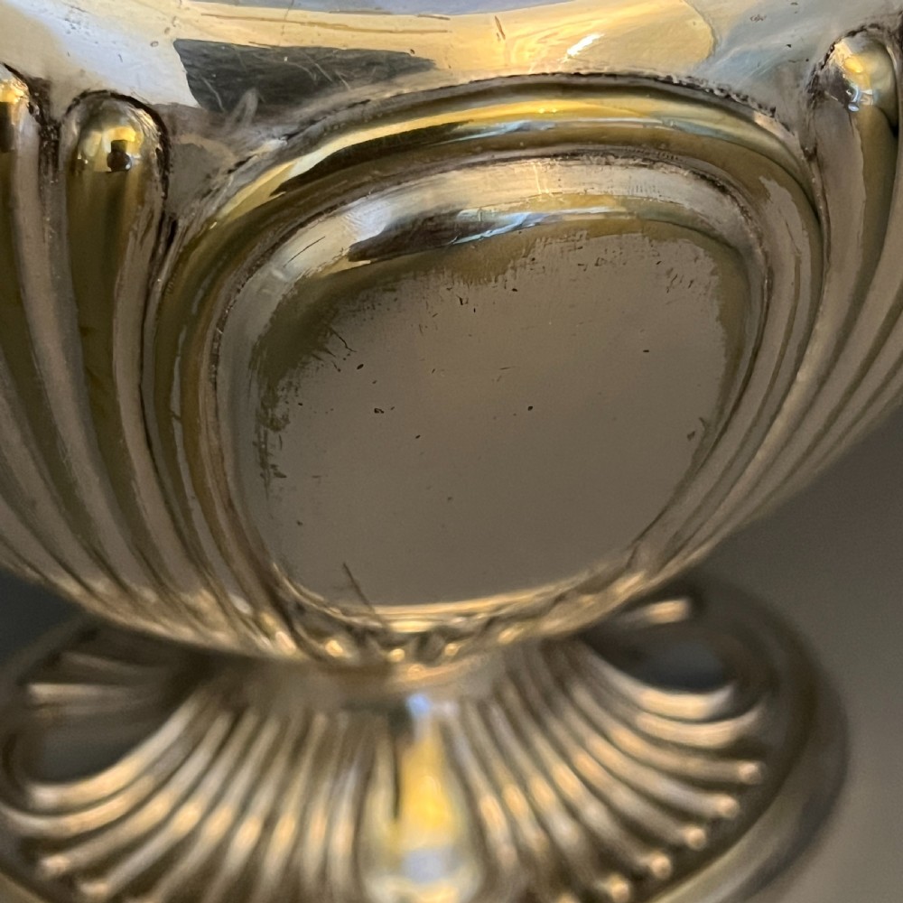A four-piece Victorian silver-plated tea and coffee set featuring a teapot, coffee pot, sugar bowl, and cream jug with fluted bodies and pedestal bases. View XIII