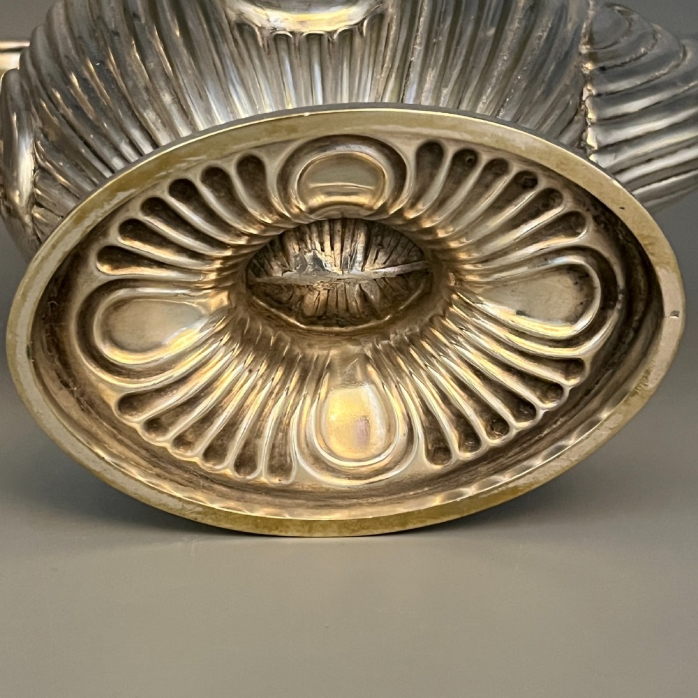 A four-piece Victorian silver-plated tea and coffee set featuring a teapot, coffee pot, sugar bowl, and cream jug with fluted bodies and pedestal bases. View XVIII