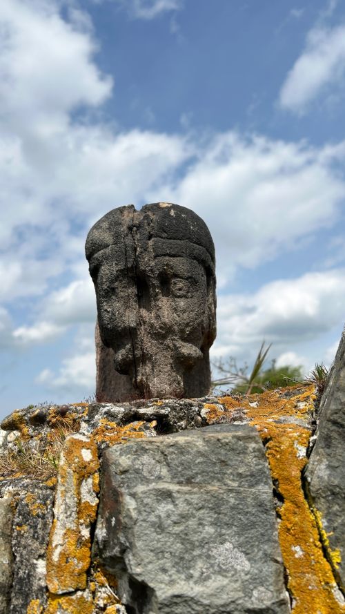 fig 1. A weathered 17th-century carved stone head fragment with defined facial features and visible surface erosion.