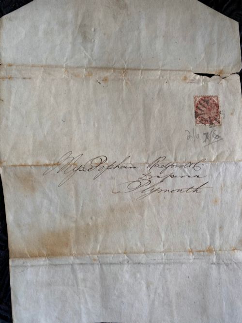 fig 2. A folded 19th-century handwritten letter on creased cream paper with cursive script and a red Queen Victoria halfpenny postage stamp.