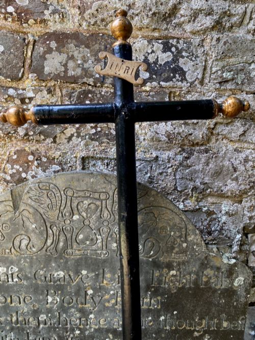fig 1. An 18th-century ebonised wooden cross with giltwood finials and an INRI scroll set upon a mould-shaped stepped base.