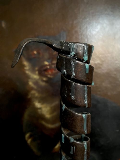 fig 1. A pair of antique wrought iron spiral candlesticks with hooked handles set into turned dark wood bases.