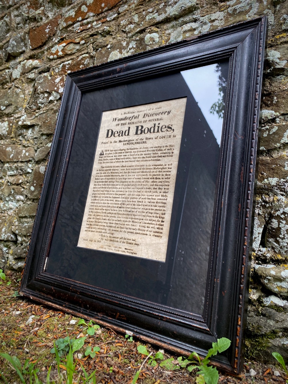 An 1823 letterpress printed broadside notice titled regarding a discovery in Louth Lincolnshire, presented in a dark ebonised wooden frame. View VI