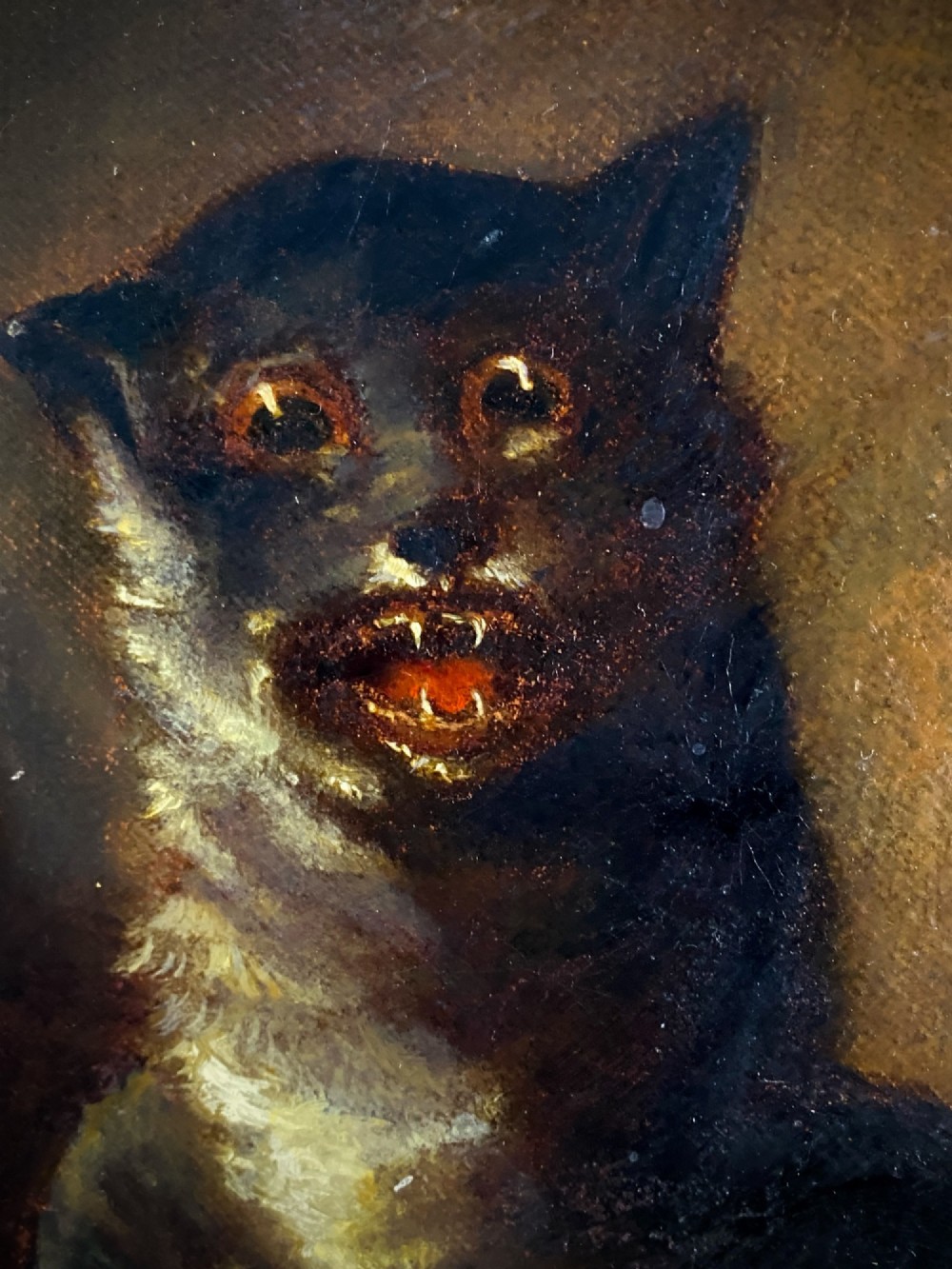 A 19th-century unframed oil painting on canvas showing a dark cat positioned beside an overturned bowl on a dark background. View V