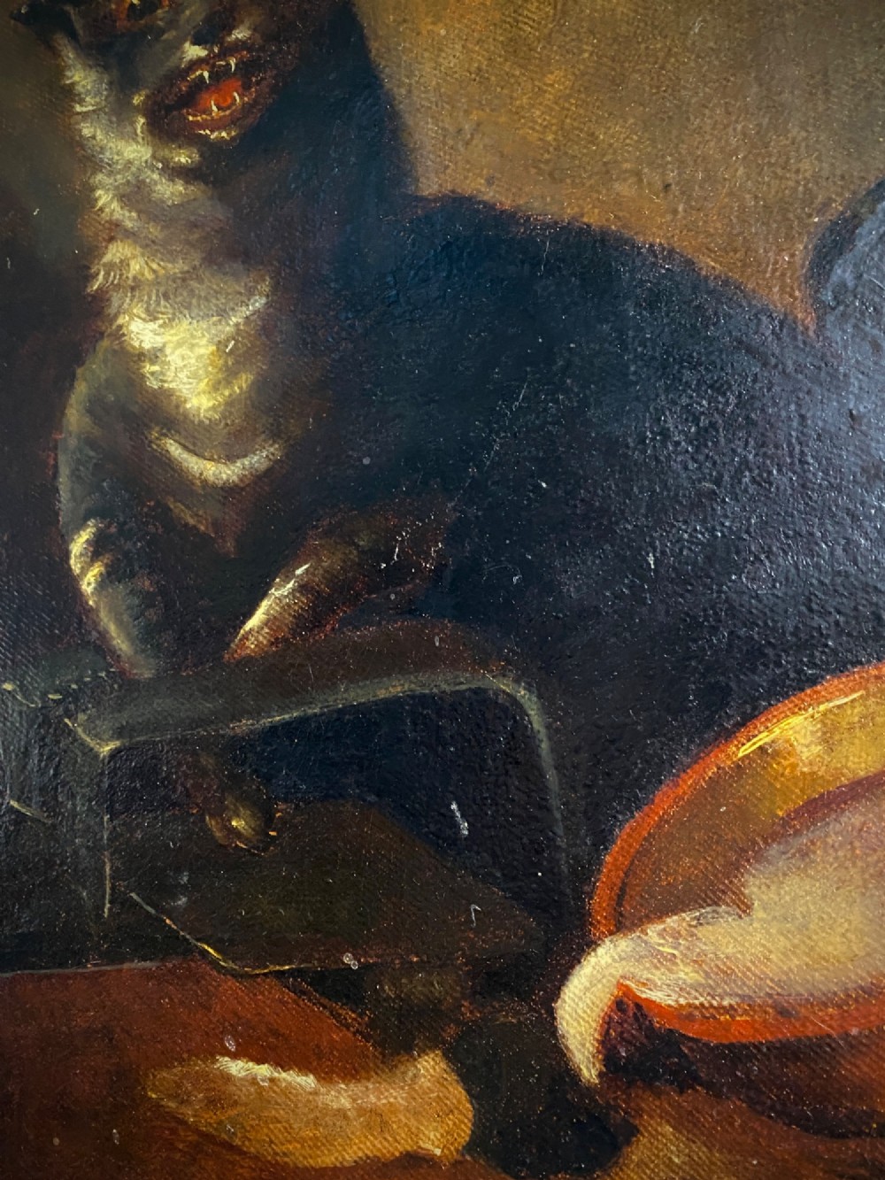 A 19th-century unframed oil painting on canvas showing a dark cat positioned beside an overturned bowl on a dark background. View VII