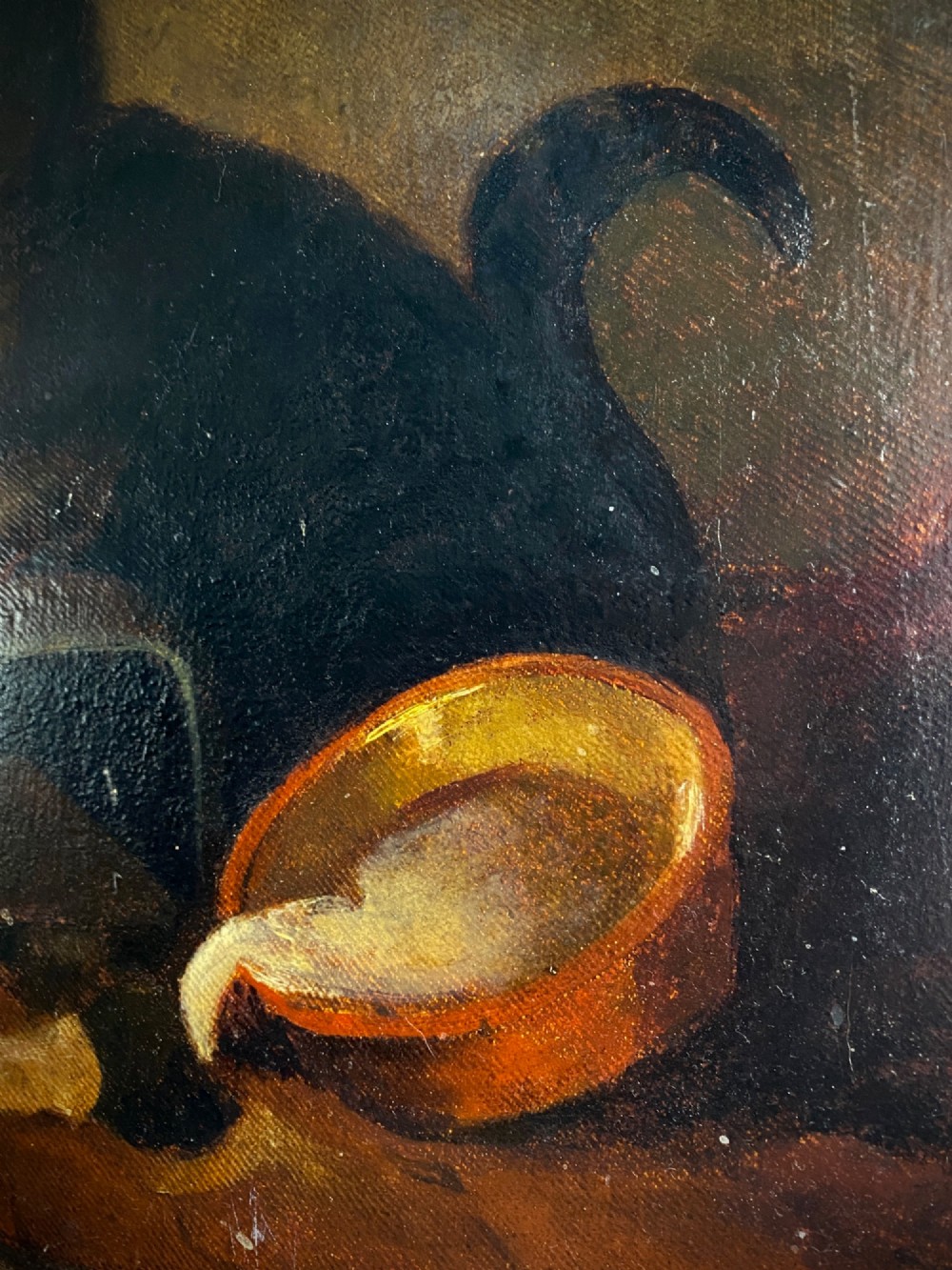 A 19th-century unframed oil painting on canvas showing a dark cat positioned beside an overturned bowl on a dark background. View VIII