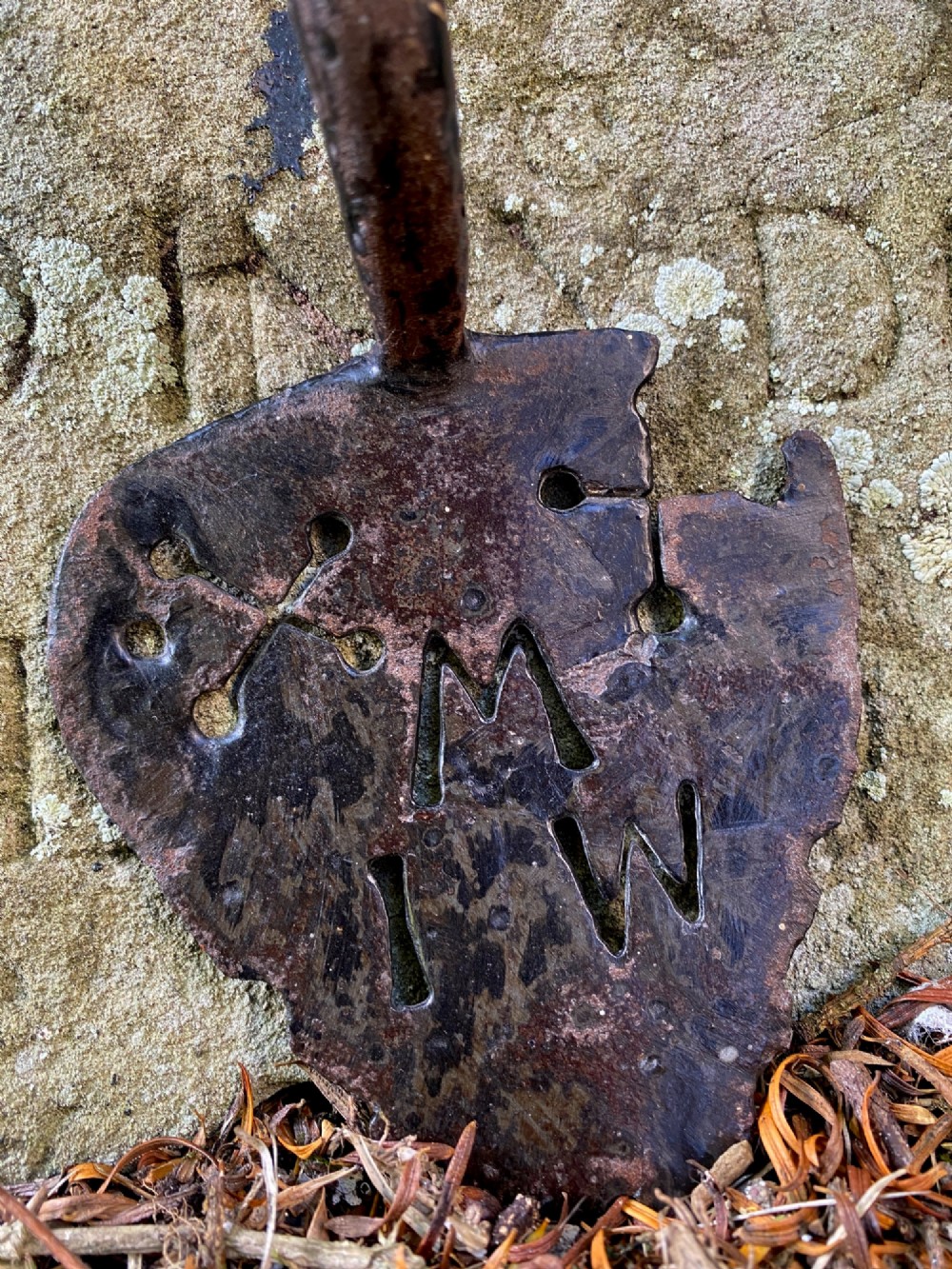 An 18th-century hand-forged wrought iron door handle featuring pierced decorative motifs, stamped initials, and the date 1730. View III