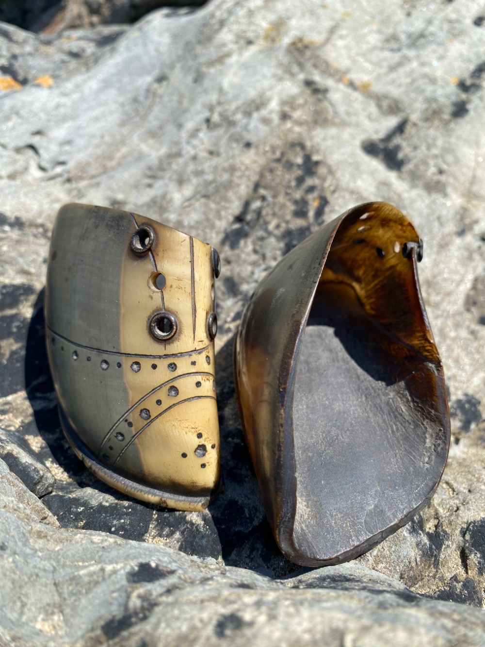 A pair of 19th-century folk art miniature shoes crafted from horn with incised shoe details and punched eyelets. View III