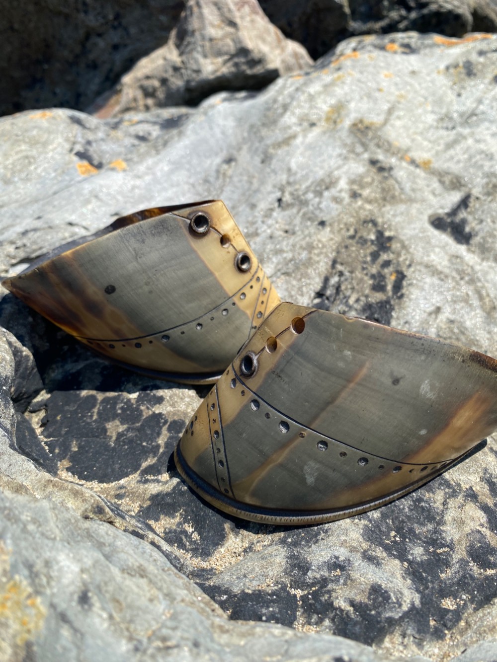 A pair of 19th-century folk art miniature shoes crafted from horn with incised shoe details and punched eyelets. View IV