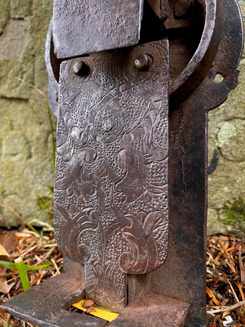 A hand-forged dark wrought iron lock plate featuring a trefoil crest, projecting key pipe, and surface oxidisation. View II