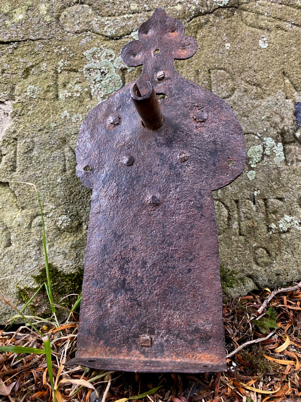 A hand-forged dark wrought iron lock plate featuring a trefoil crest, projecting key pipe, and surface oxidisation. View III
