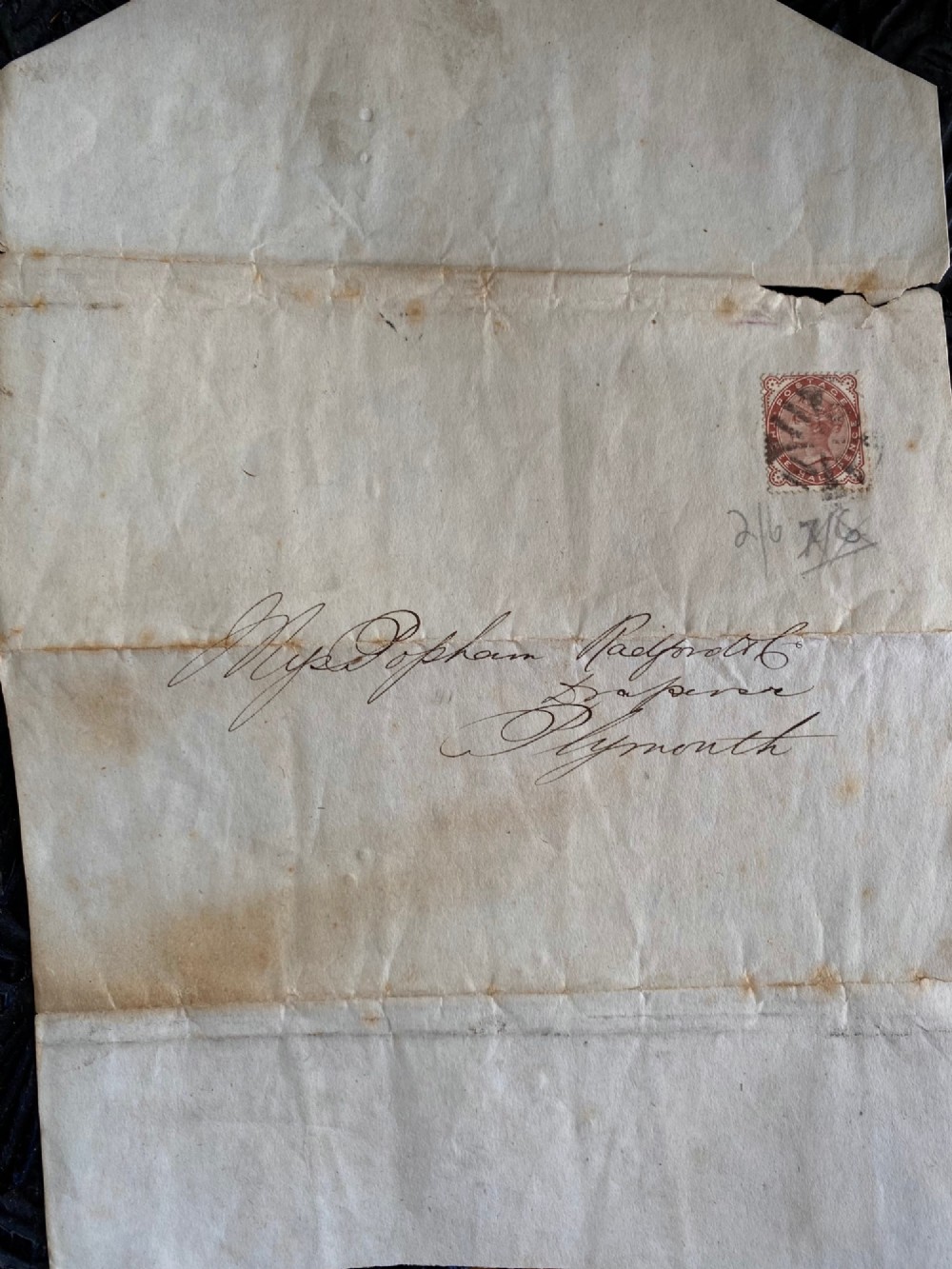 A folded 19th-century handwritten letter on creased cream paper with cursive script and a red Queen Victoria halfpenny postage stamp. View III