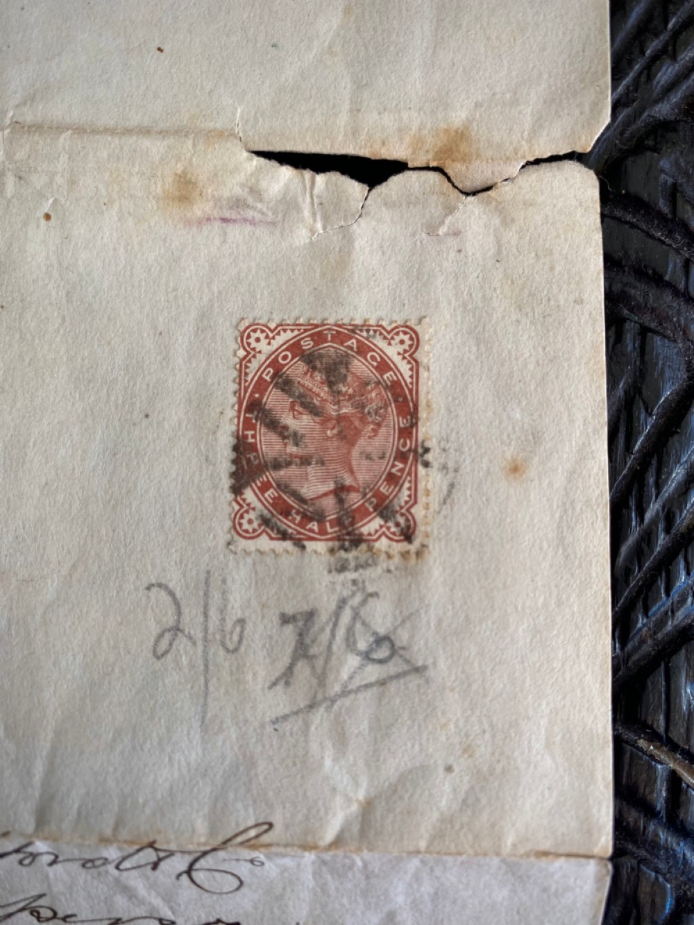 A folded 19th-century handwritten letter on creased cream paper with cursive script and a red Queen Victoria halfpenny postage stamp. View V
