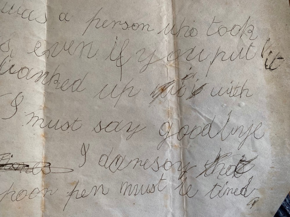 A folded 19th-century handwritten letter on creased cream paper with cursive script and a red Queen Victoria halfpenny postage stamp. View X