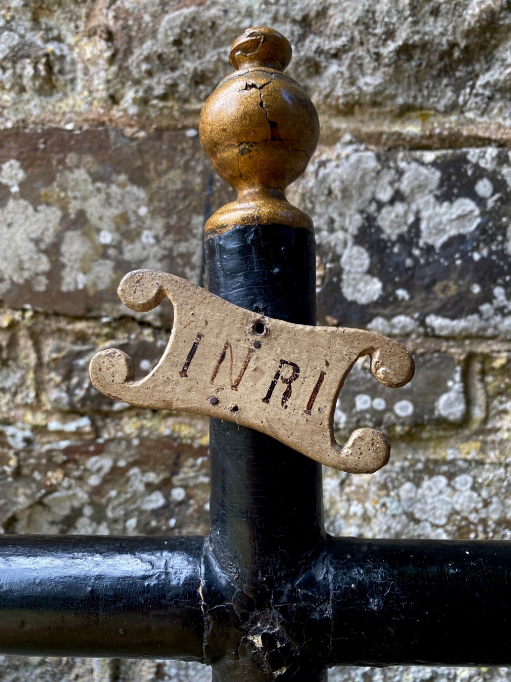 An 18th-century ebonised wooden cross with giltwood finials and an INRI scroll set upon a mould-shaped stepped base. View III