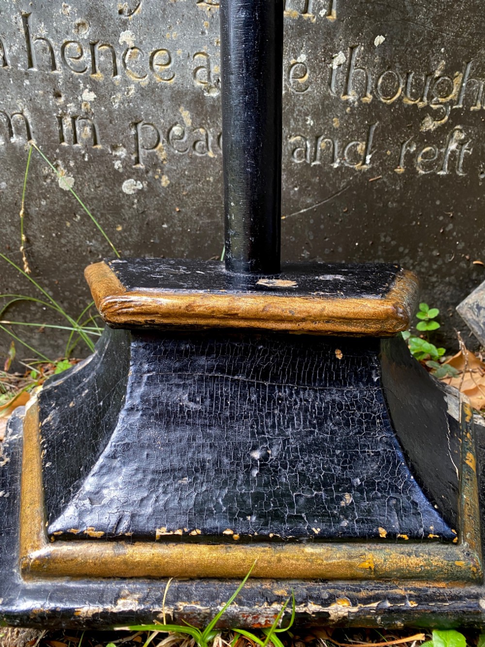 An 18th-century ebonised wooden cross with giltwood finials and an INRI scroll set upon a mould-shaped stepped base. View VI