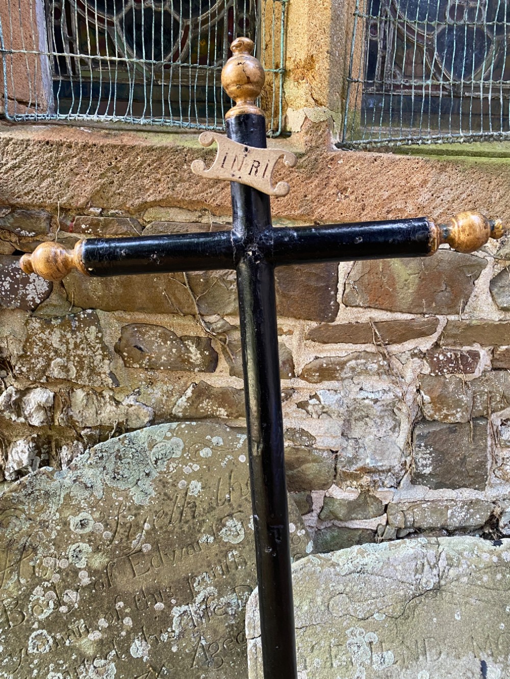 An 18th-century ebonised wooden cross with giltwood finials and an INRI scroll set upon a mould-shaped stepped base. View VII