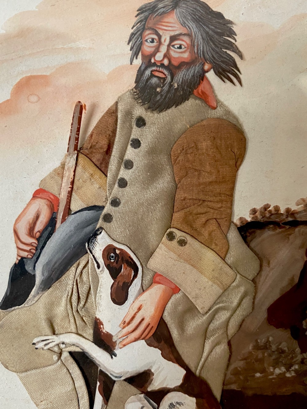 A late 18th-century Georgian folk art picture depicting a seated gamekeeper in fabric attire resting his hand on a spotted dog. View IX
