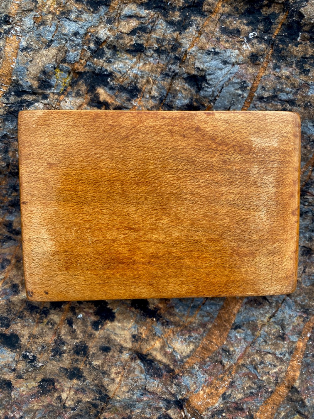 A rectangular carved wooden box lid depicting a uniformed military figure with a detector alongside hand-incised lettering detailing UK locations and dates. View V