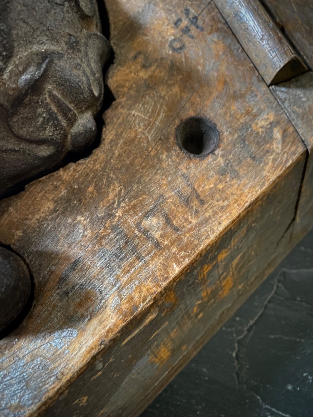 A three-piece set of carved wooden pattern moulds featuring a central seated gargoyle figure flanked by two bat-like wing panels with red paint accents. View XII