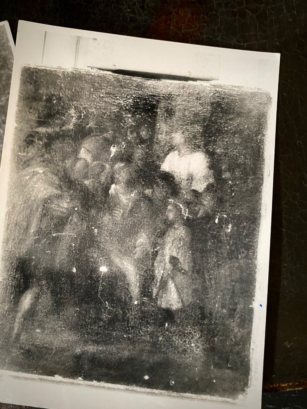 A dark sixteenth-century oil painting featuring figures dressed in red and dark garments with pronounced surface craquelure, accompanied by two infrared scan prints. View V