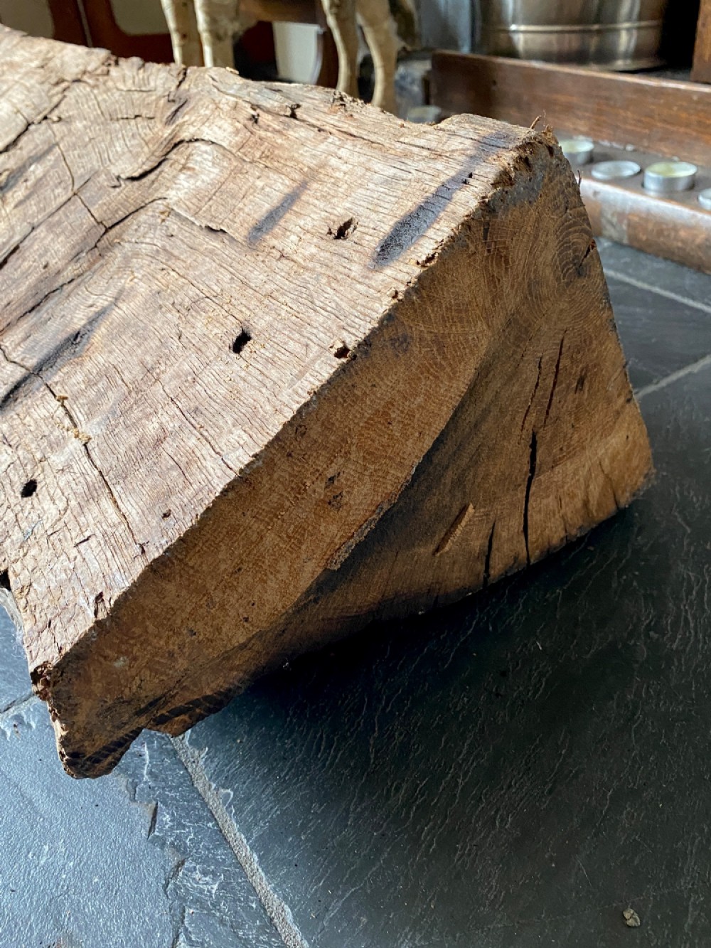 A tall, hand-hewn 17th-century solid oak beam featuring multiple dark apotropaic taper burn marks along its weathered wood surface. View XIII