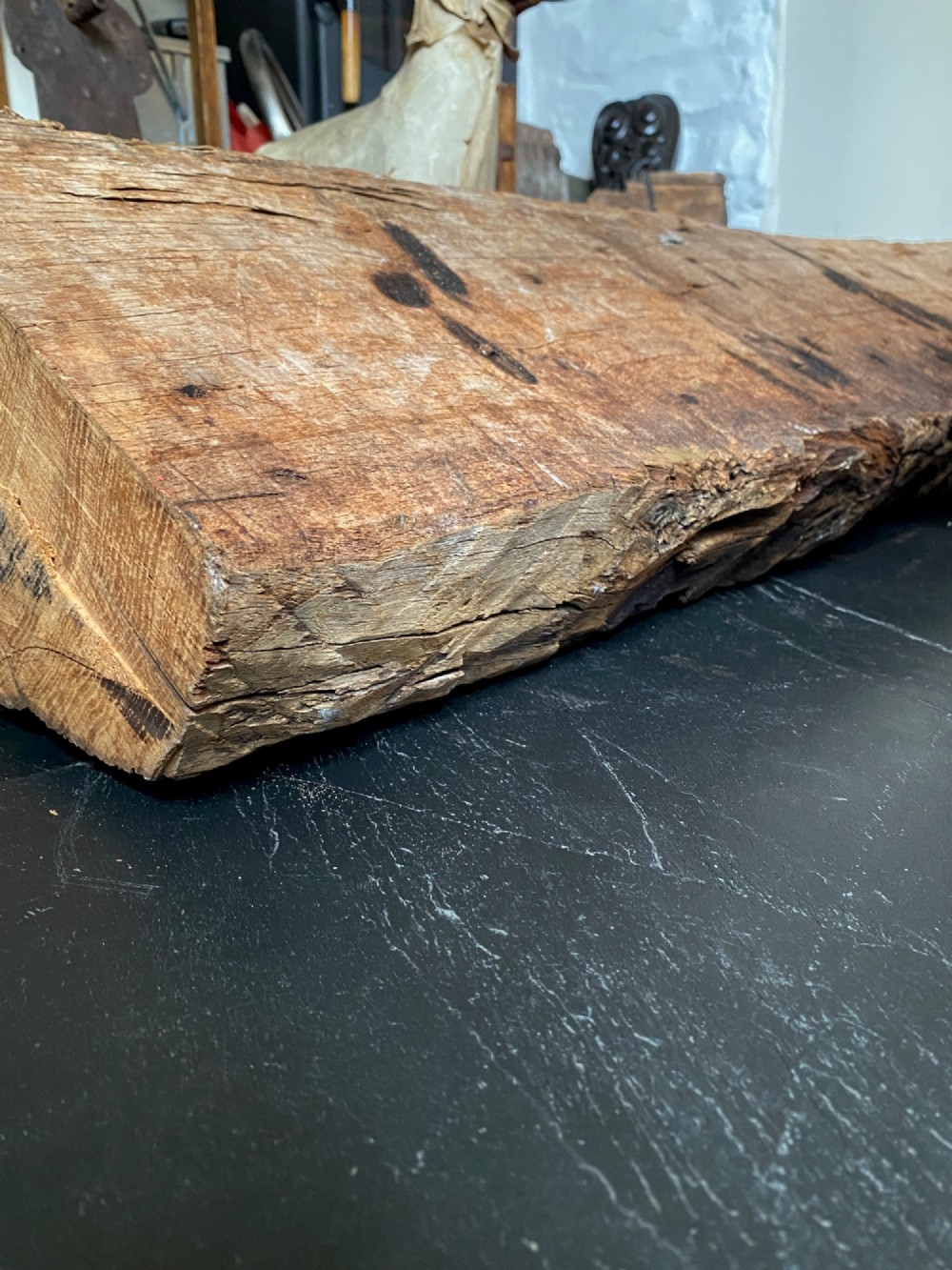 A tall, hand-hewn 17th-century solid oak beam featuring multiple dark apotropaic taper burn marks along its weathered wood surface. View XIV