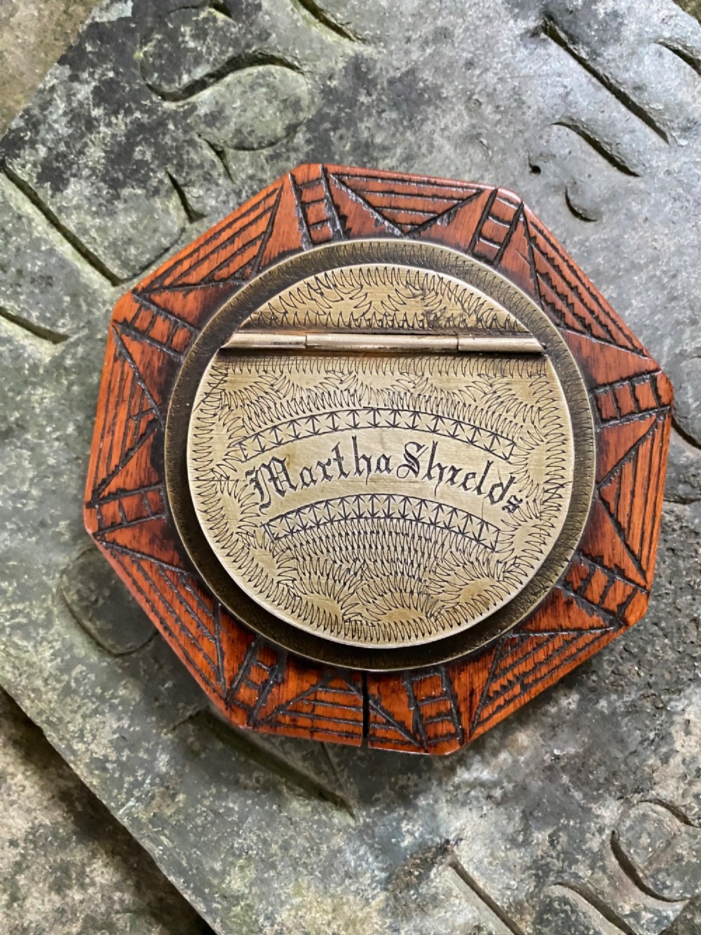 An early nineteenth-century octagonal carved wooden treen snuff box featuring an engraved brass hinged lid inscribed with the name Martha Shields. View II