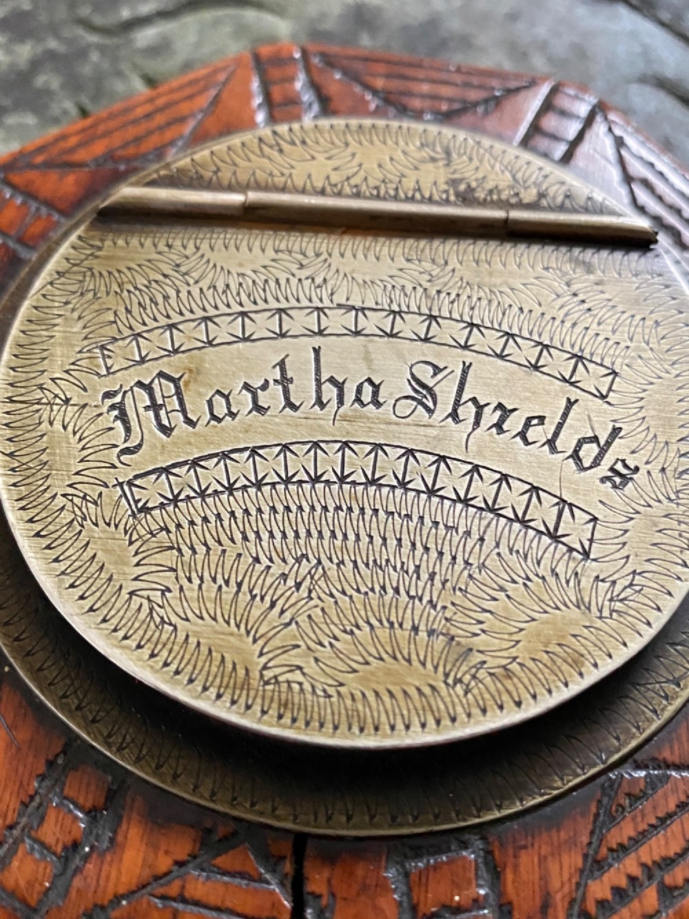 An early nineteenth-century octagonal carved wooden treen snuff box featuring an engraved brass hinged lid inscribed with the name Martha Shields. View V