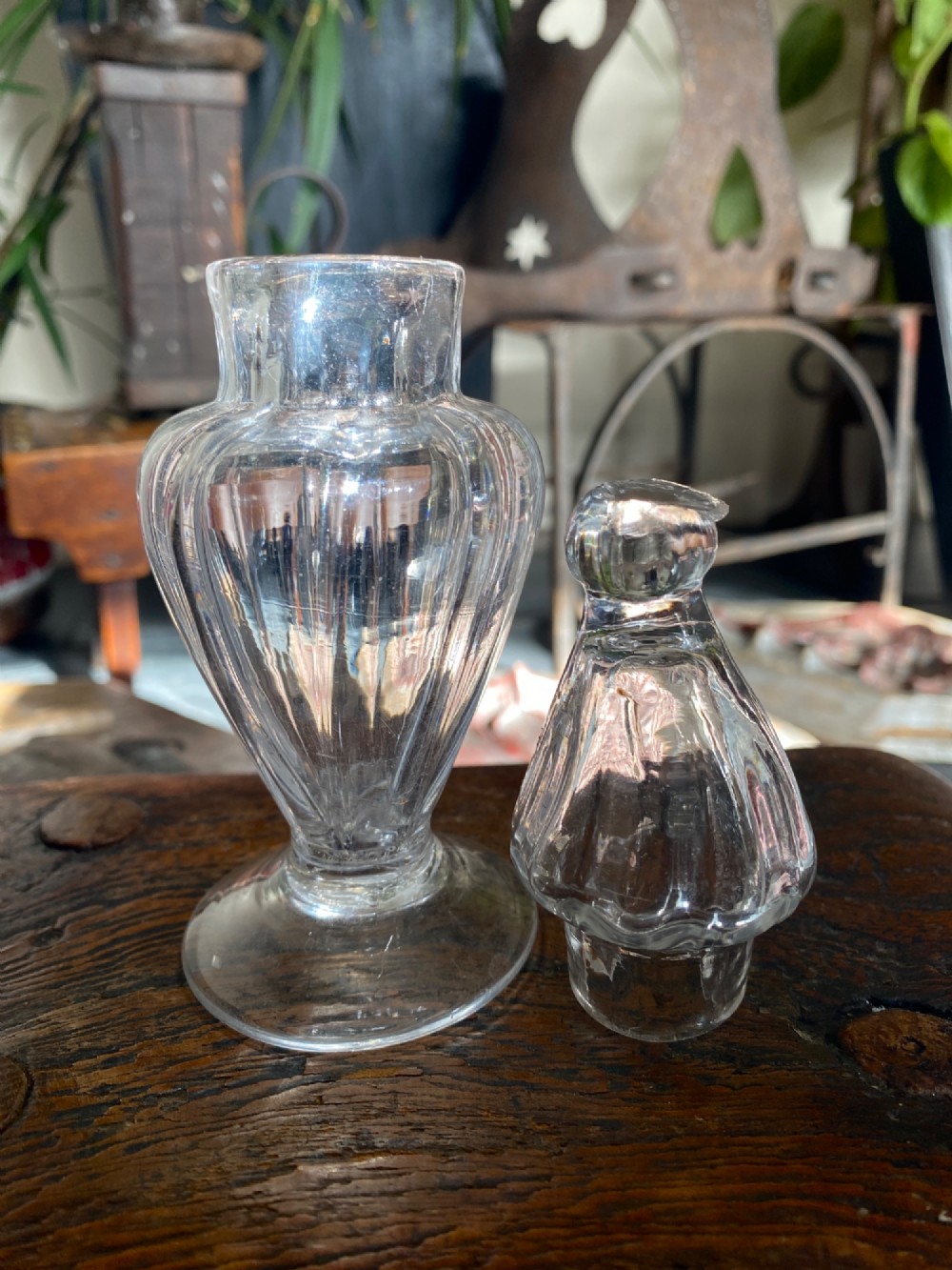 An 18th-century clear hand-blown glass dry mustard jar featuring vertical fluting, a circular footed base, and a removable pointed glass stopper. View II