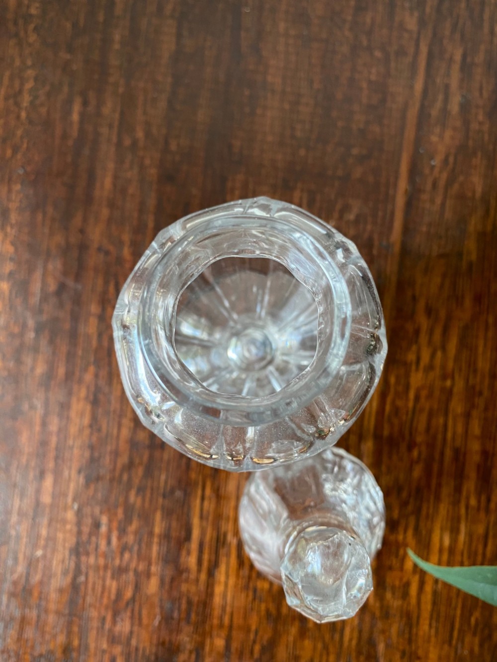 An 18th-century clear hand-blown glass dry mustard jar featuring vertical fluting, a circular footed base, and a removable pointed glass stopper. View V