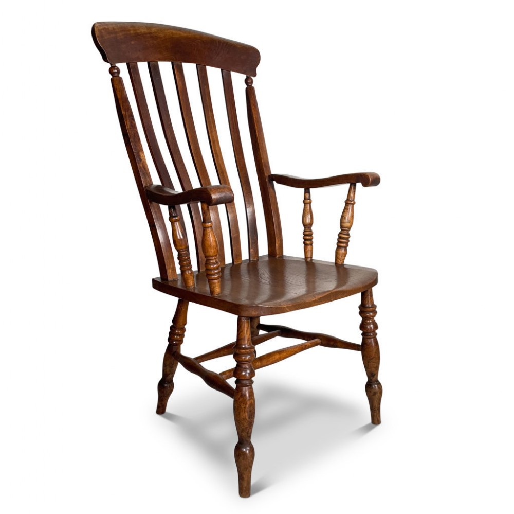 A Victorian country lath back carver chair made from ash and elm wood, featuring vertical back slats, curved armrests, a shaped solid seat, and turned legs.