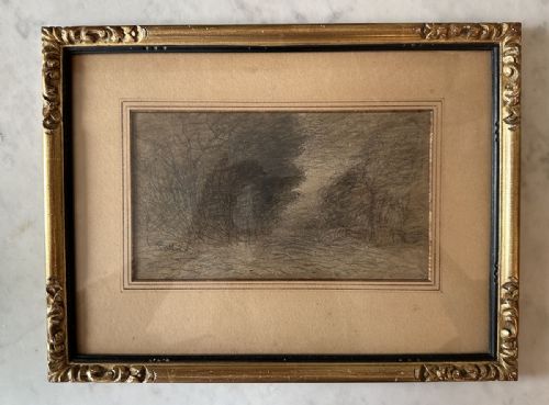 fig 2. An antique monochrome charcoal drawing depicting a dense wooded landscape set within a beige mount and an ornate gilt frame.