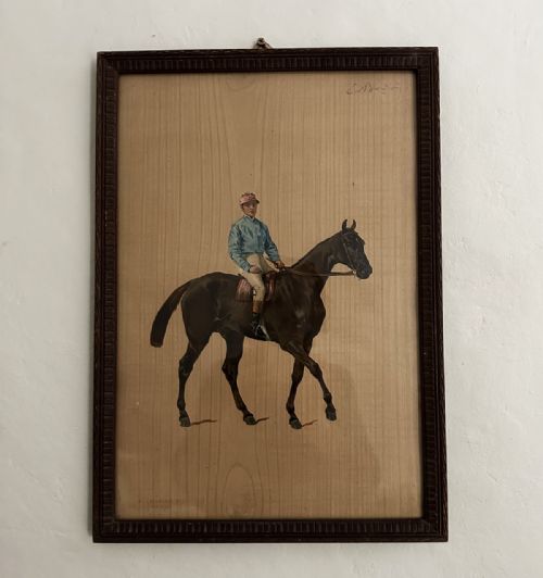 fig 1. An antique French print depicting a jockey in white silks and a red cap riding a galloping brown racehorse against a plain beige paper background.