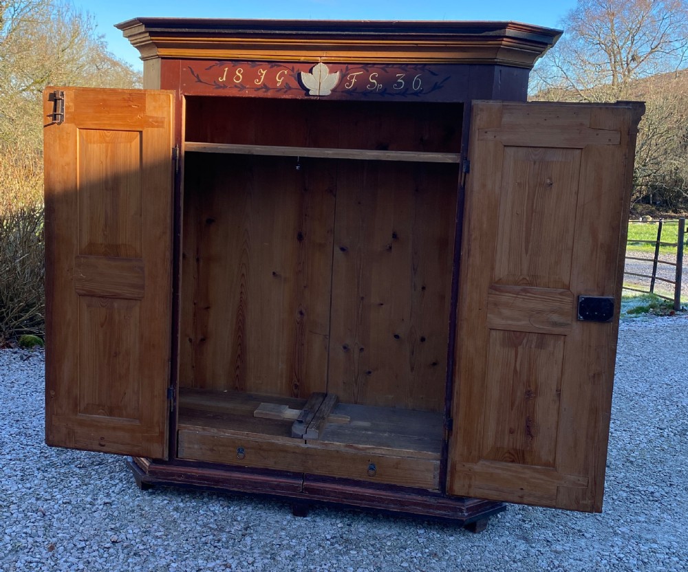 A two-door painted softwood armoire with burgundy side panels, a central classical pilaster, and hand-painted floral and bird motifs on cream door panels. View III