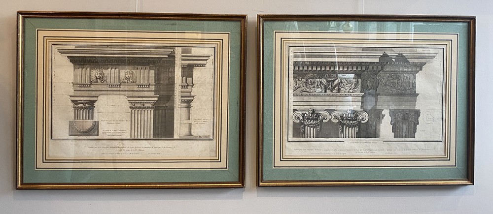 A pair of 18th-century architectural copperplate engravings depicting classical columns and entablatures, presented in sage green mounts and gilt frames.
