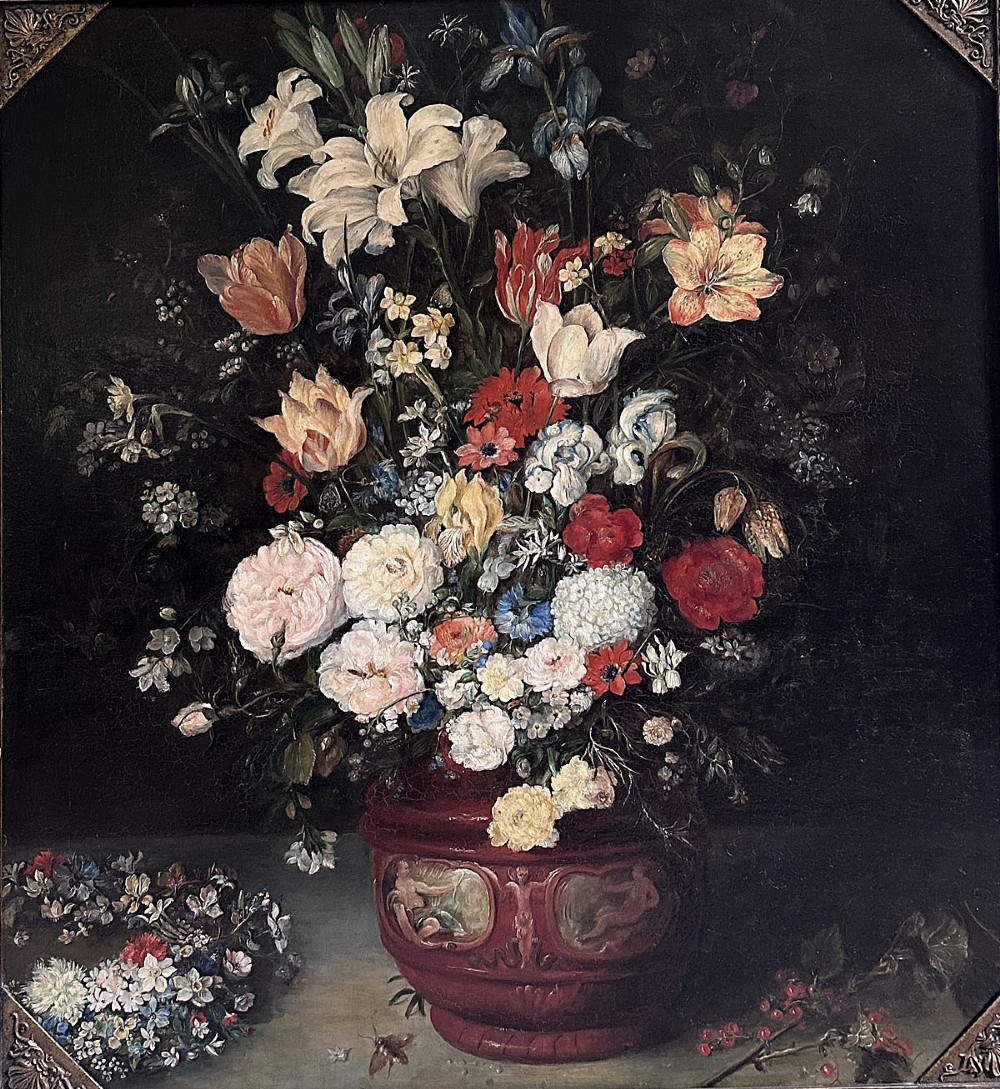 An antique oil painting depicting a dense arrangement of colourful flowers inside a terracotta-toned urn against a dark background.