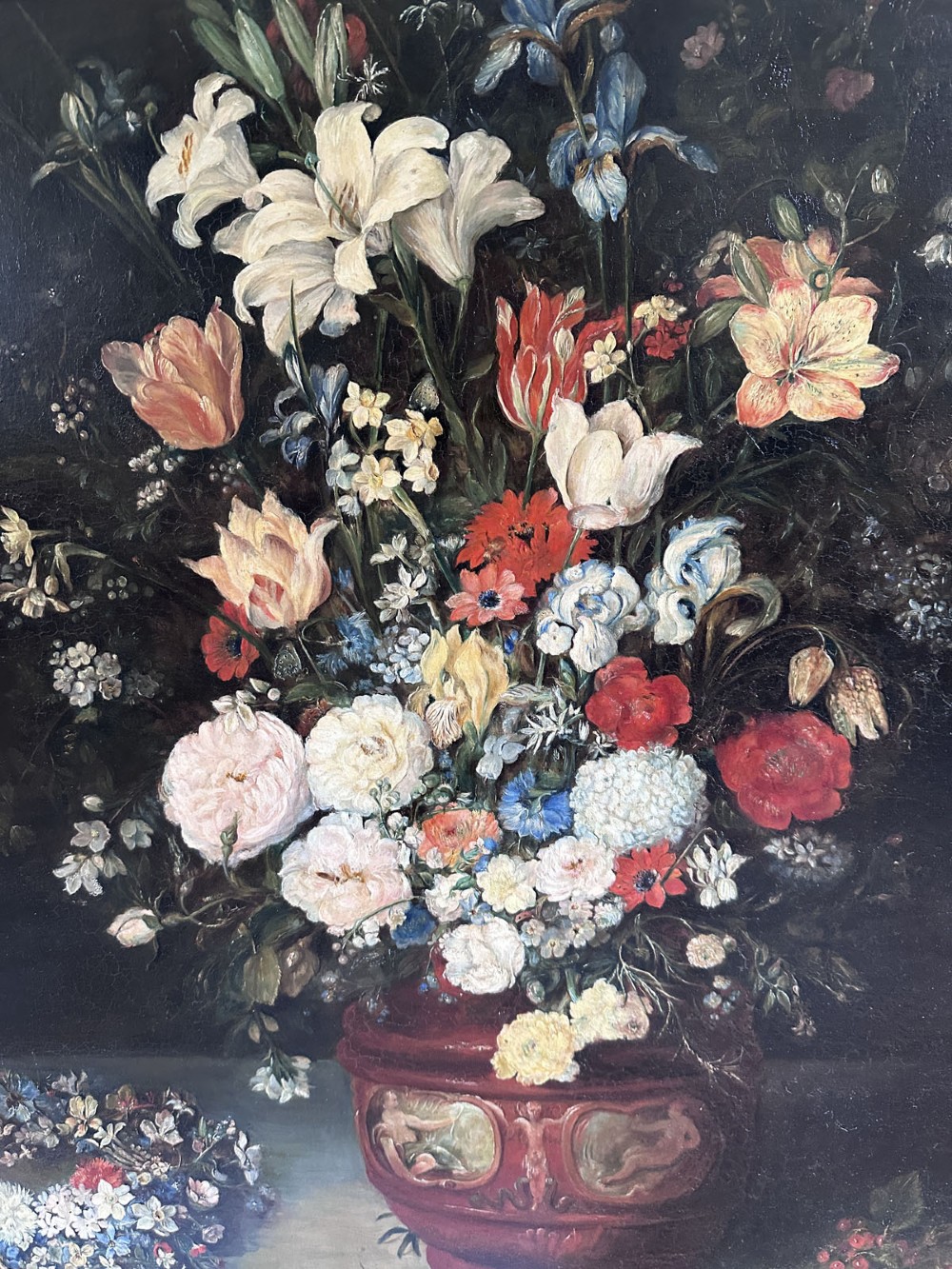 An antique oil painting depicting a dense arrangement of colourful flowers inside a terracotta-toned urn against a dark background. View IV