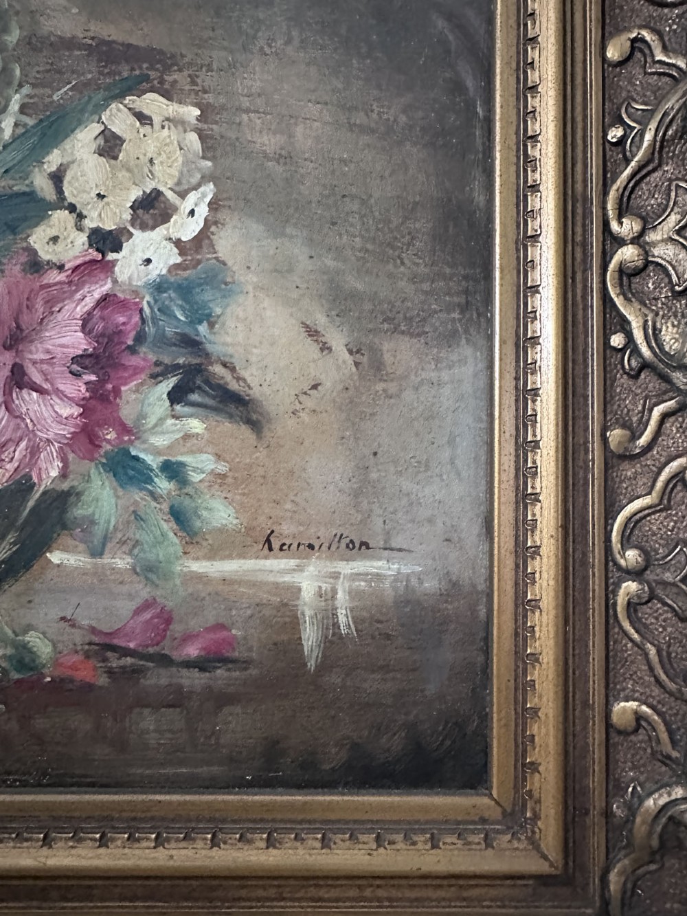 An antique oil painting depicting a colourful floral arrangement inside a footed glass bowl against a dark textured background. View V