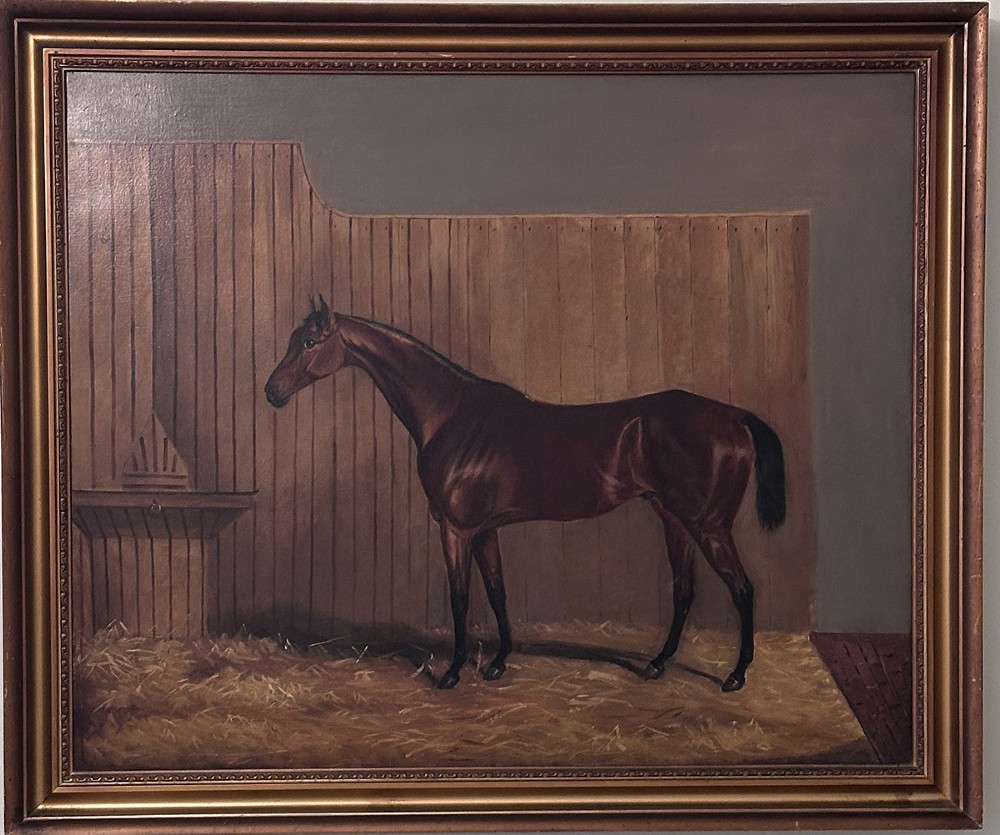 An oil painting depicting a bay racehorse standing in profile inside a wooden stable stall lined with straw. View II