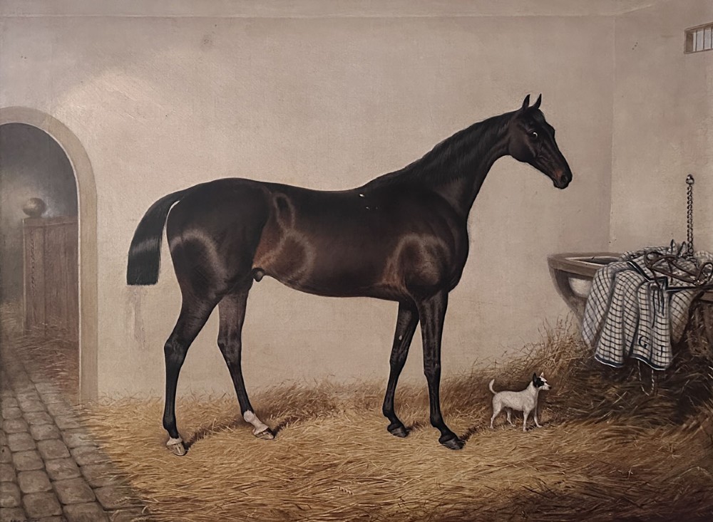An antique oil painting depicting a dark bay horse standing inside a stable alongside a small terrier dog.