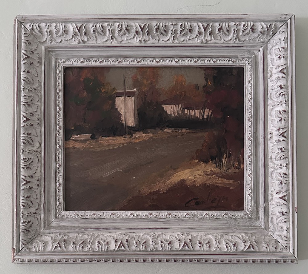 An oil painting depicting a quiet village road in autumn with muted brown and ochre foliage surrounding white buildings under an overcast sky. View II